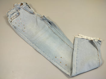 Jeans clair, étoiles sur le côté. Légère petite tache.