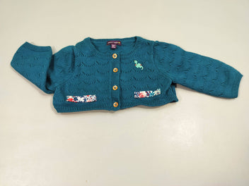 Gilet court tricot bleu pétrole, médaillon dinosaure poches fleuries