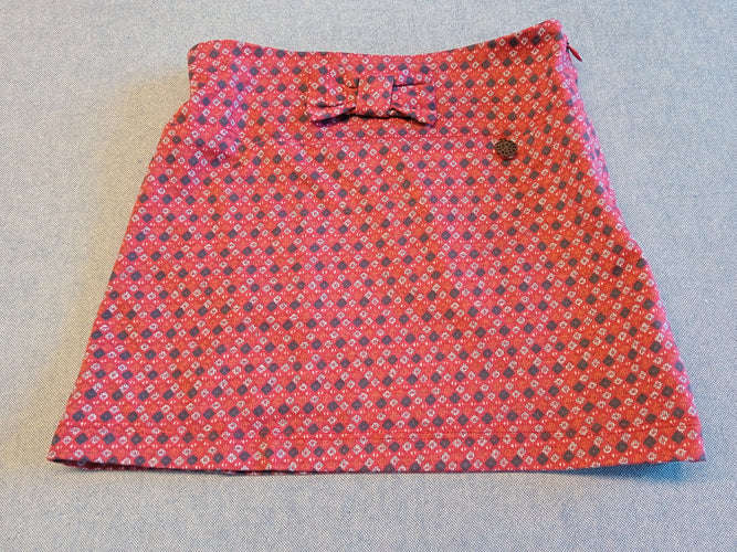 Jupe rouge avec petits motifs , noeud et petit médaillon, moins cher chez Petit Kiwi