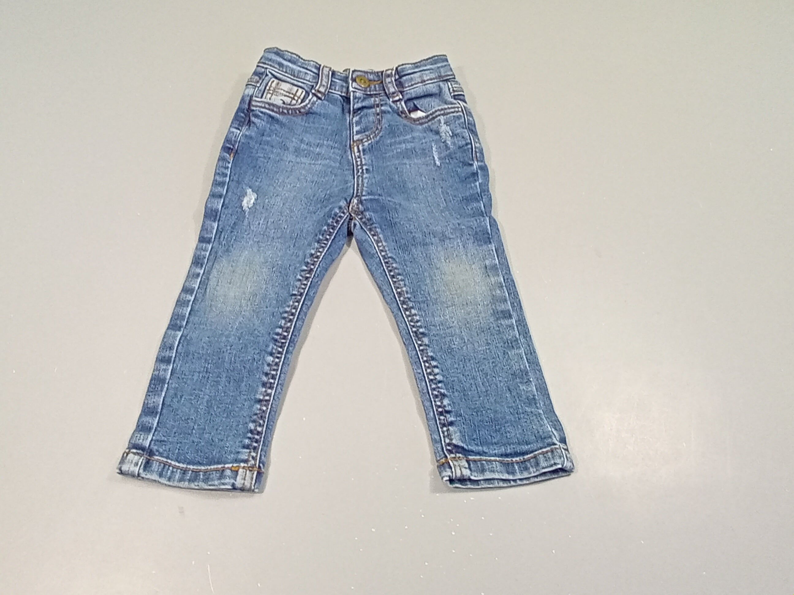 Jeans effet eraillé, poches à carreaux