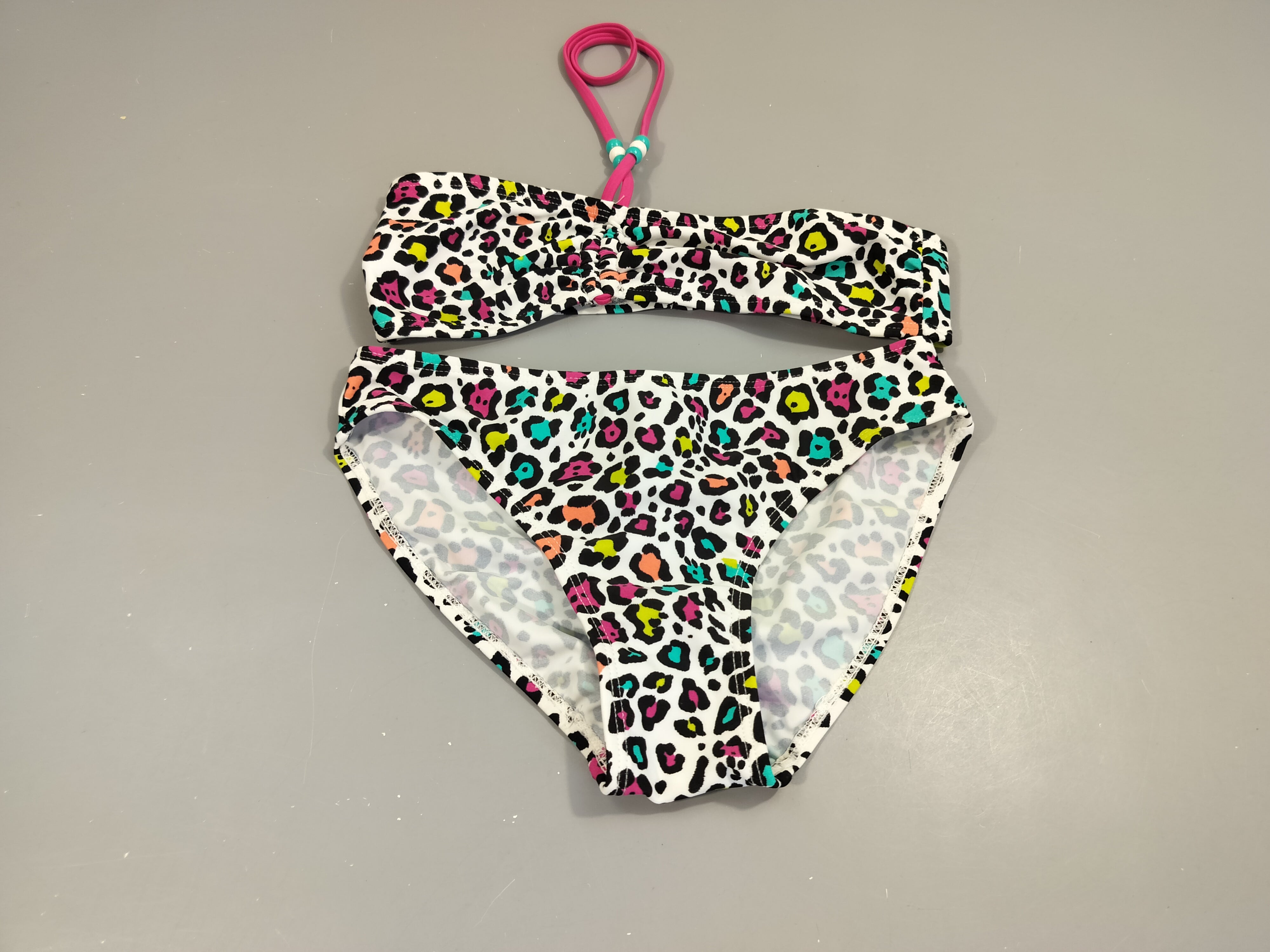 Bikini blanc  motifs colorés, à noué au cou par cordon rose avec perles