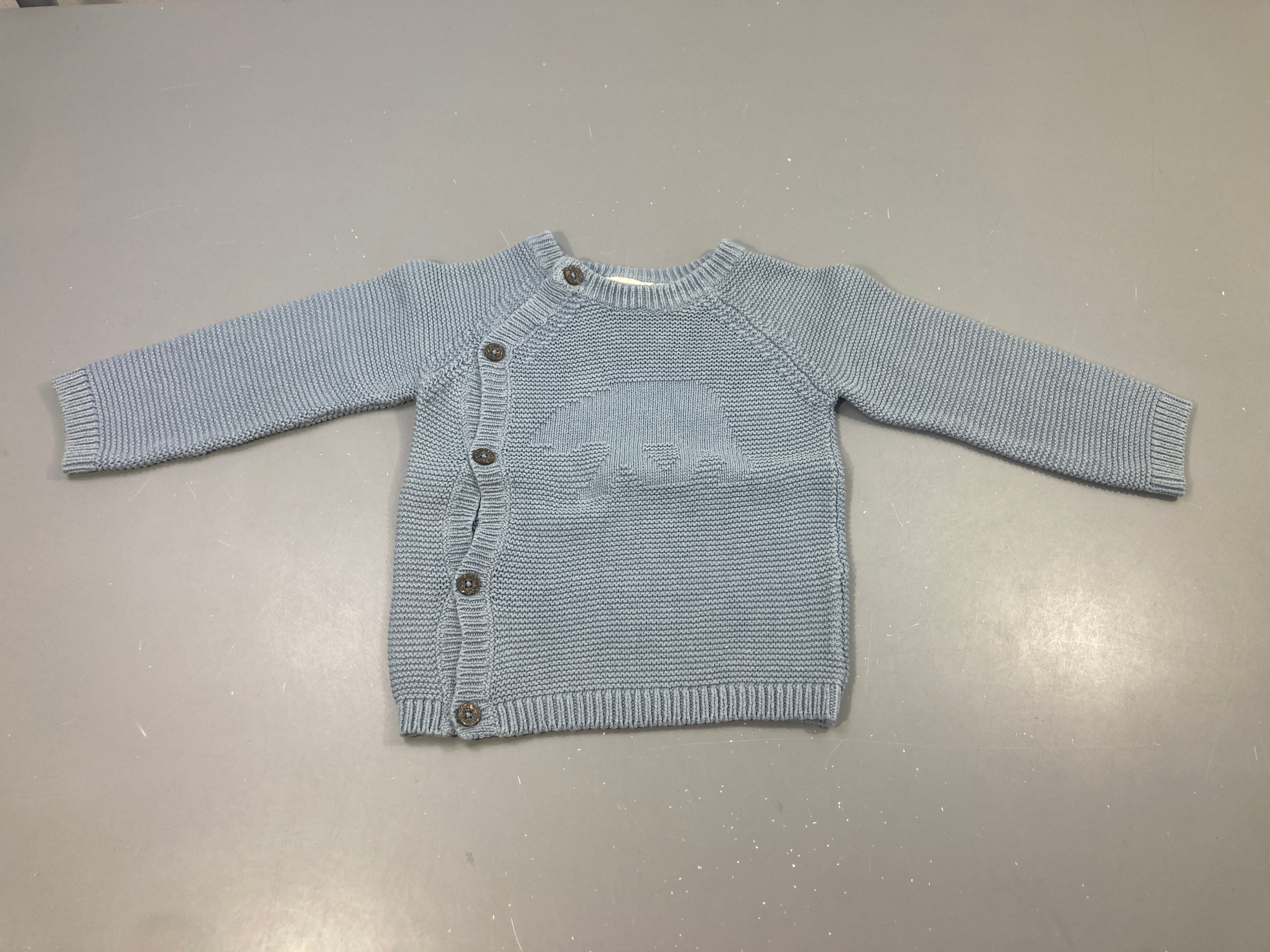Gilet mailles bleu-clair boutons coté