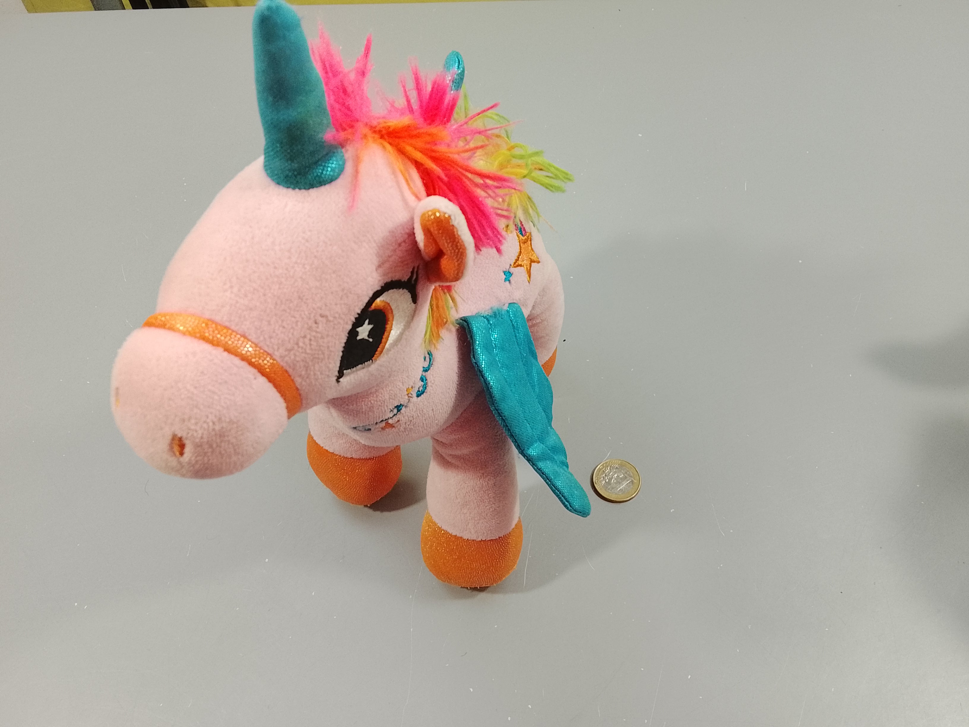 Peluche licorne rose, crête multicolore, ailes bleues
