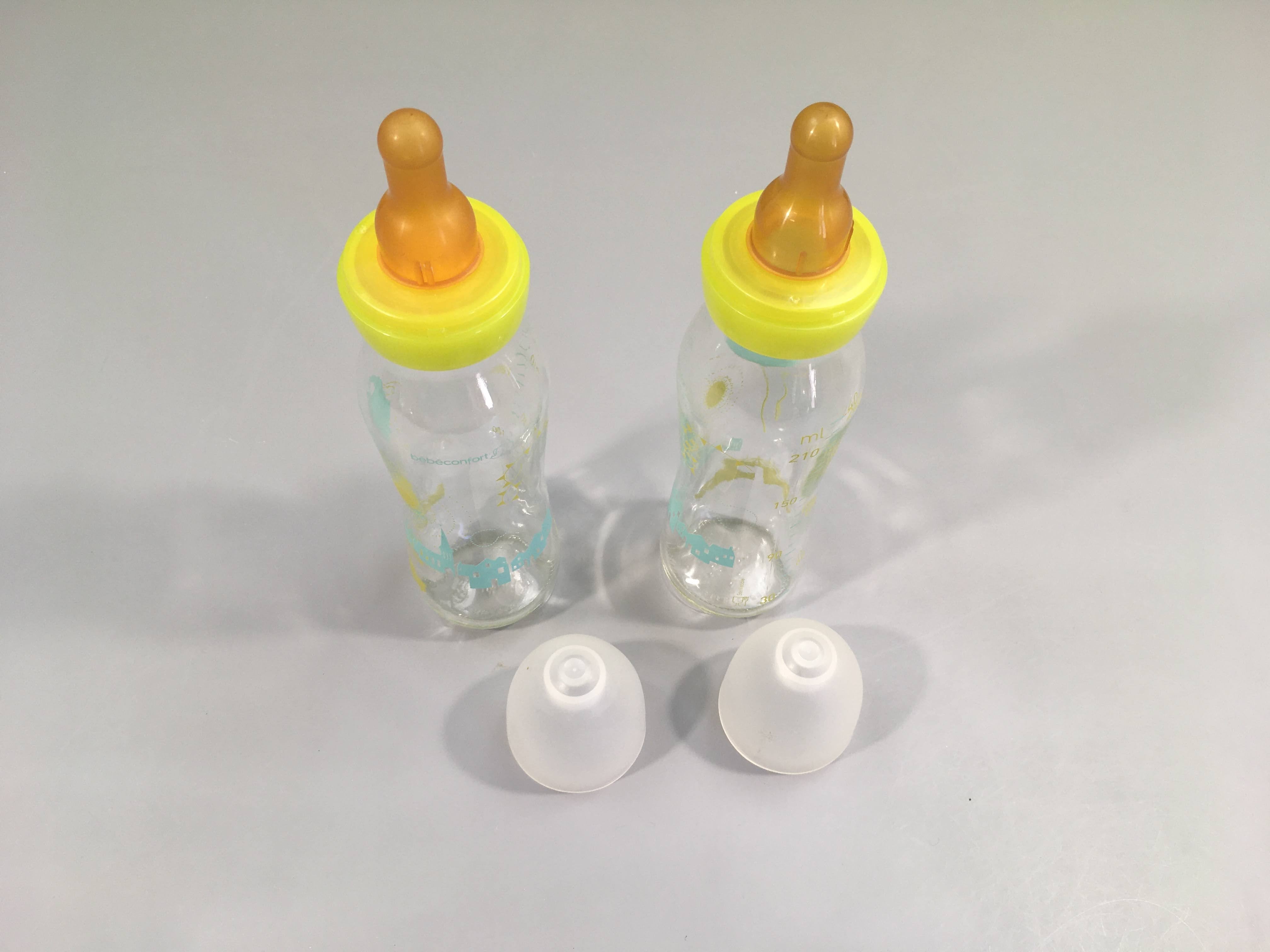 2 biberons en verre Bébé confort, dessins chateau, ballons, ... 240ml , tétine 3 vitesses en caoutchouc