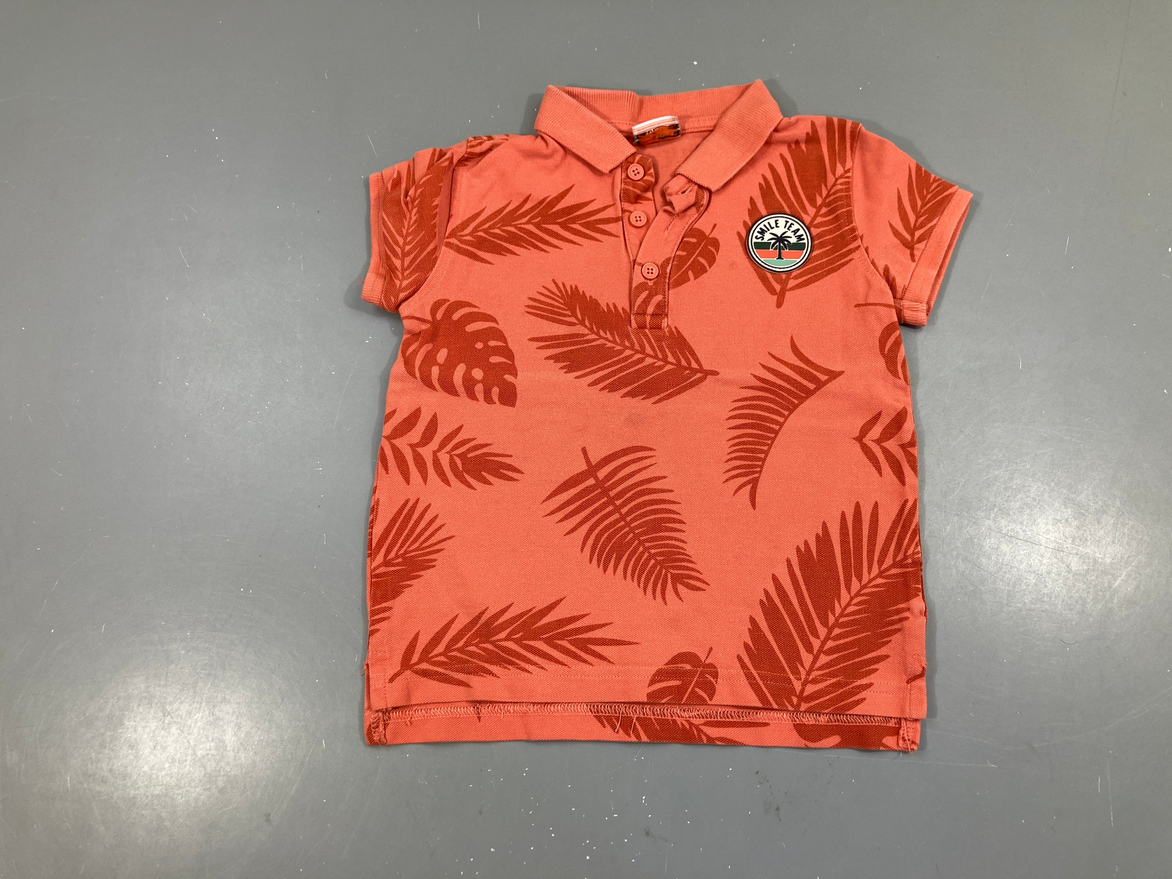 Polo m.c orangé feuillage
