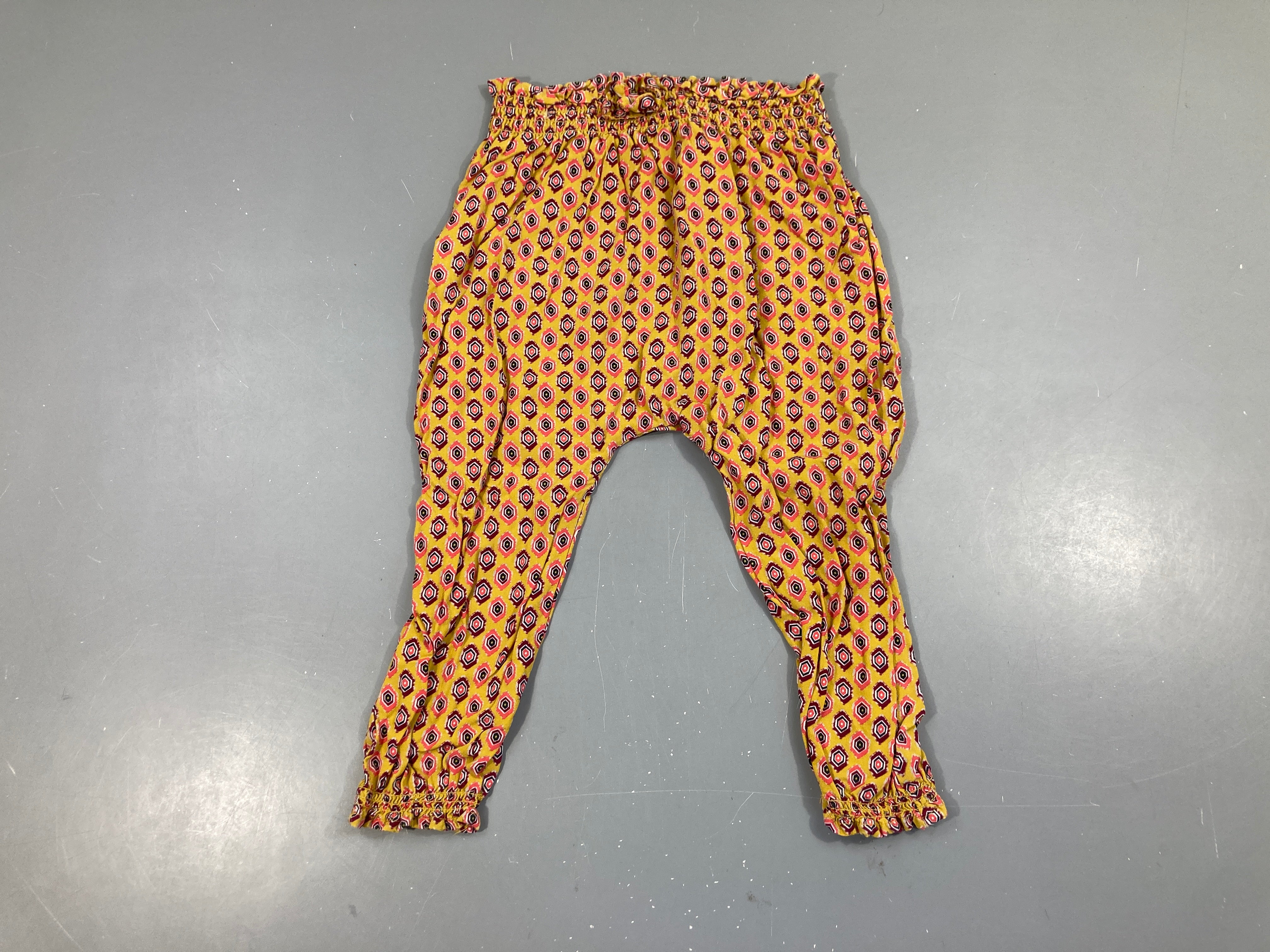 Pantalon fluide orange motifs rose