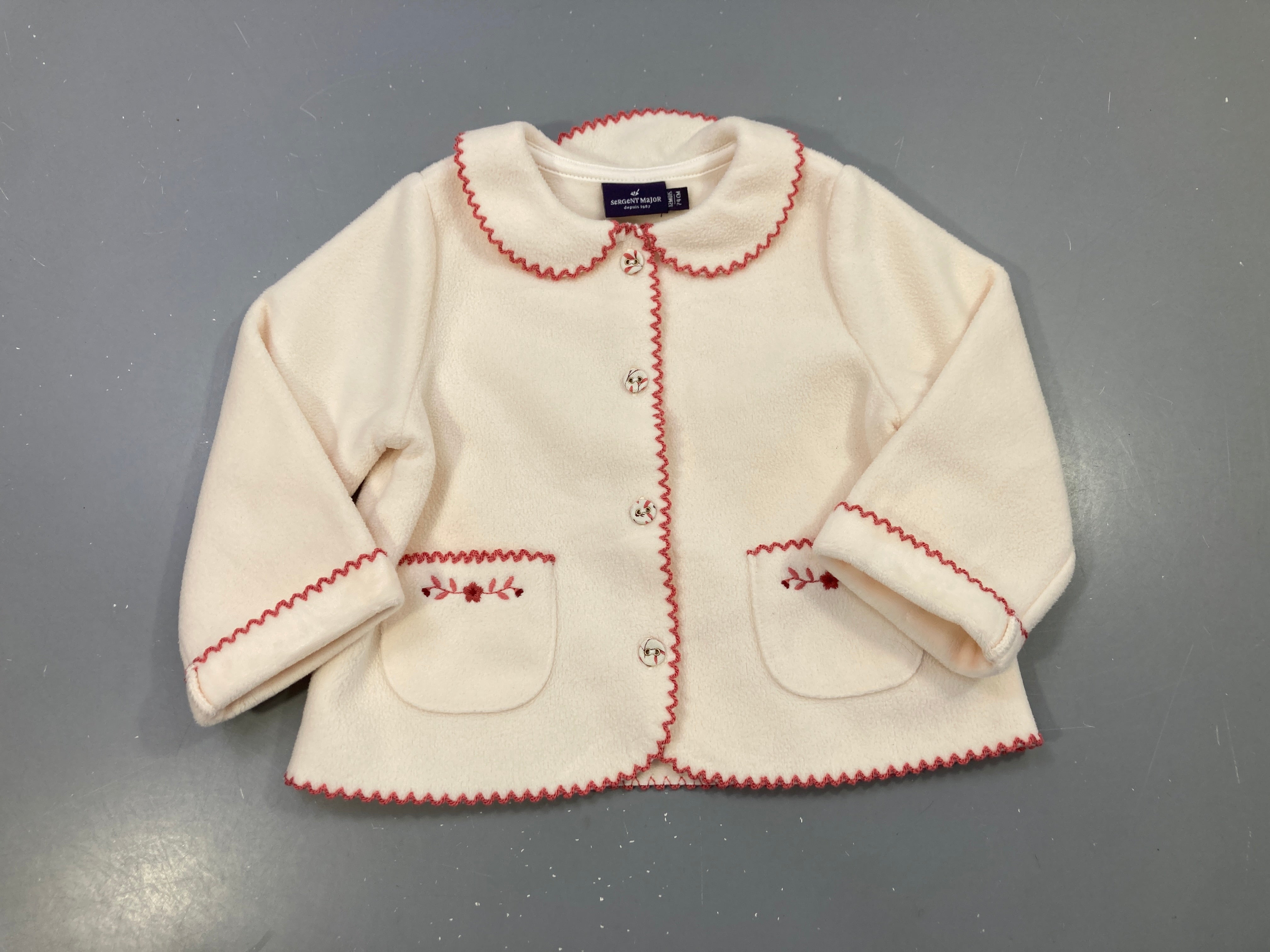 Gilet écru polaire col claudine, bordure festonnée rose, poches brodées