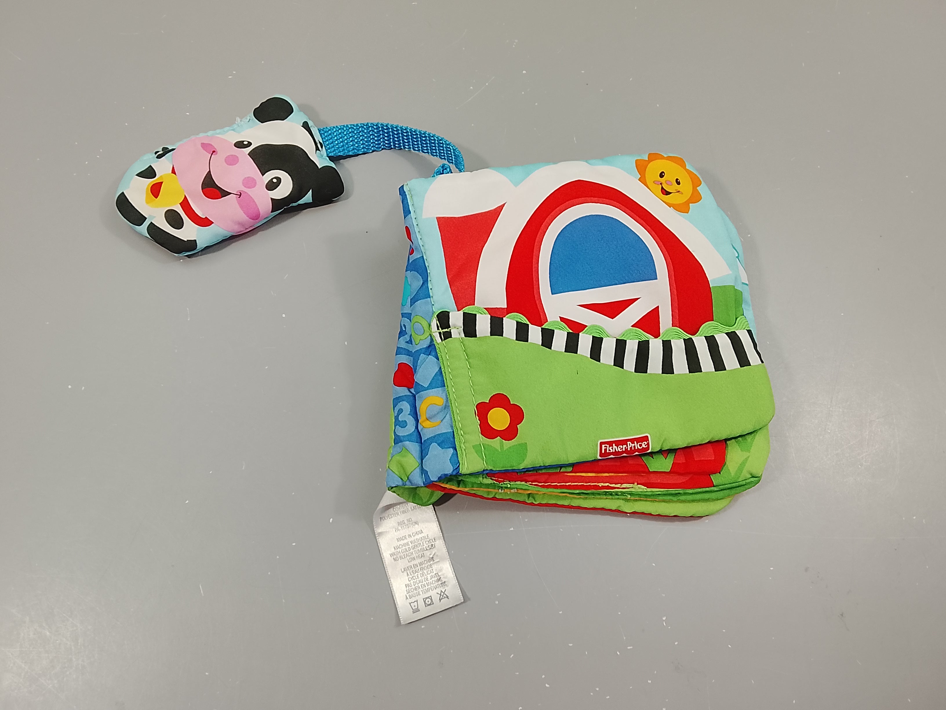 Livre d'éveil en tissus, vache  à  grelot