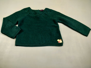 Pull tricot vert, fines paillettes. Sorte de broche sur le dessous