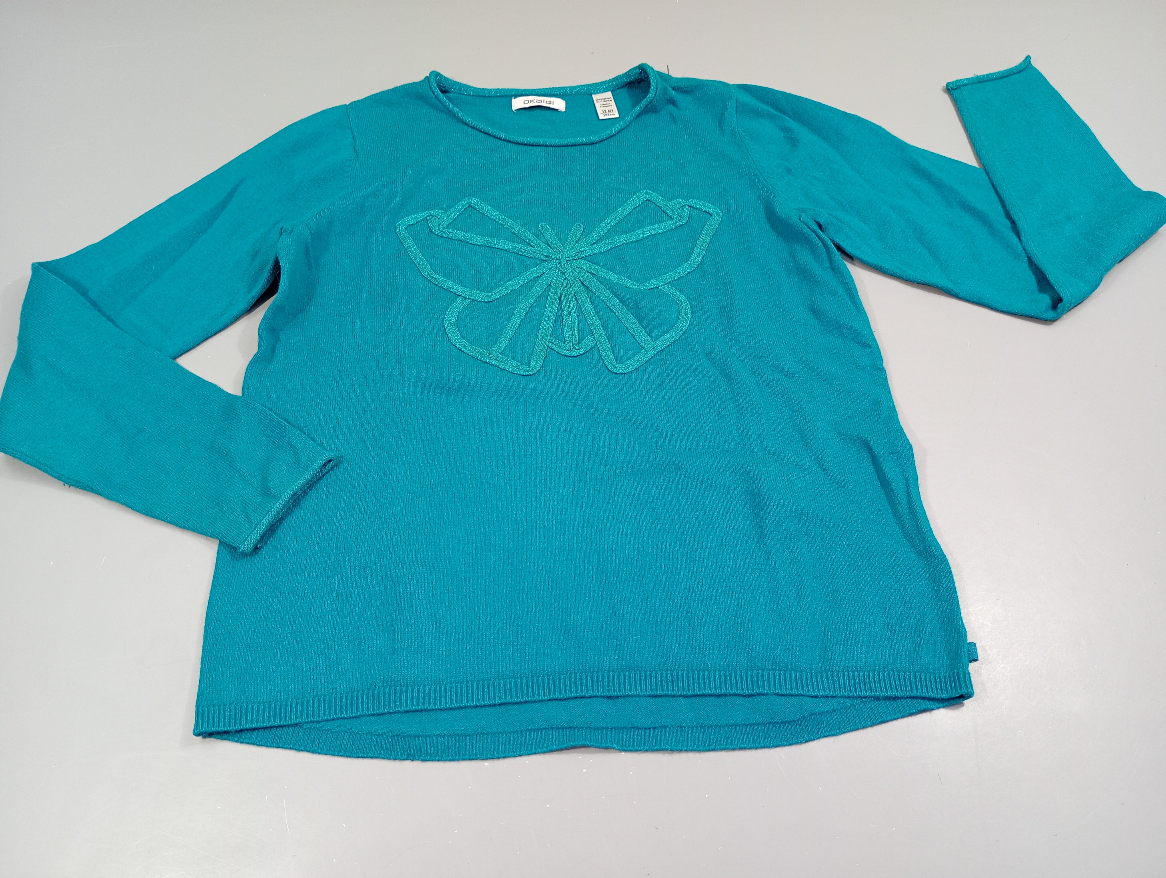 Pull turquoise , papillon pailleté